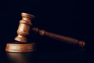 judge-gavel-close-up-on-paper-background-law-and-2021-12-09-01-21-18-utc