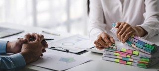 businessman-working-on-stacks-of-documents-to-sear-2023-05-30-07-48-23-utc